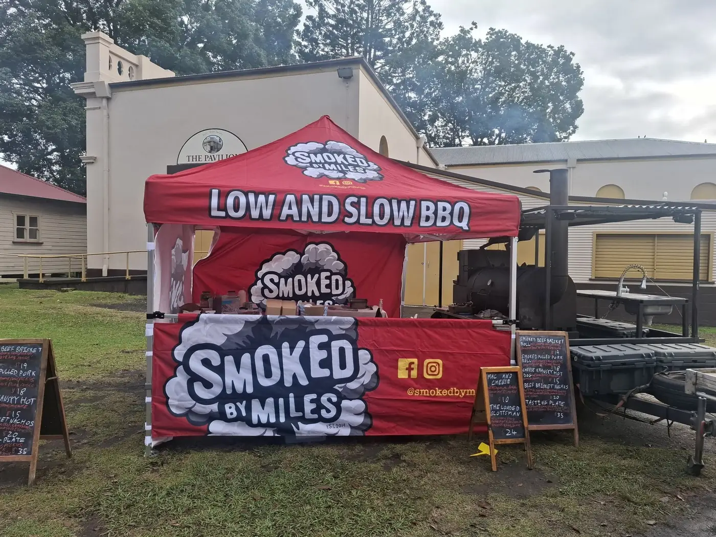 Smoked by Miles tent and smoker set up for an event